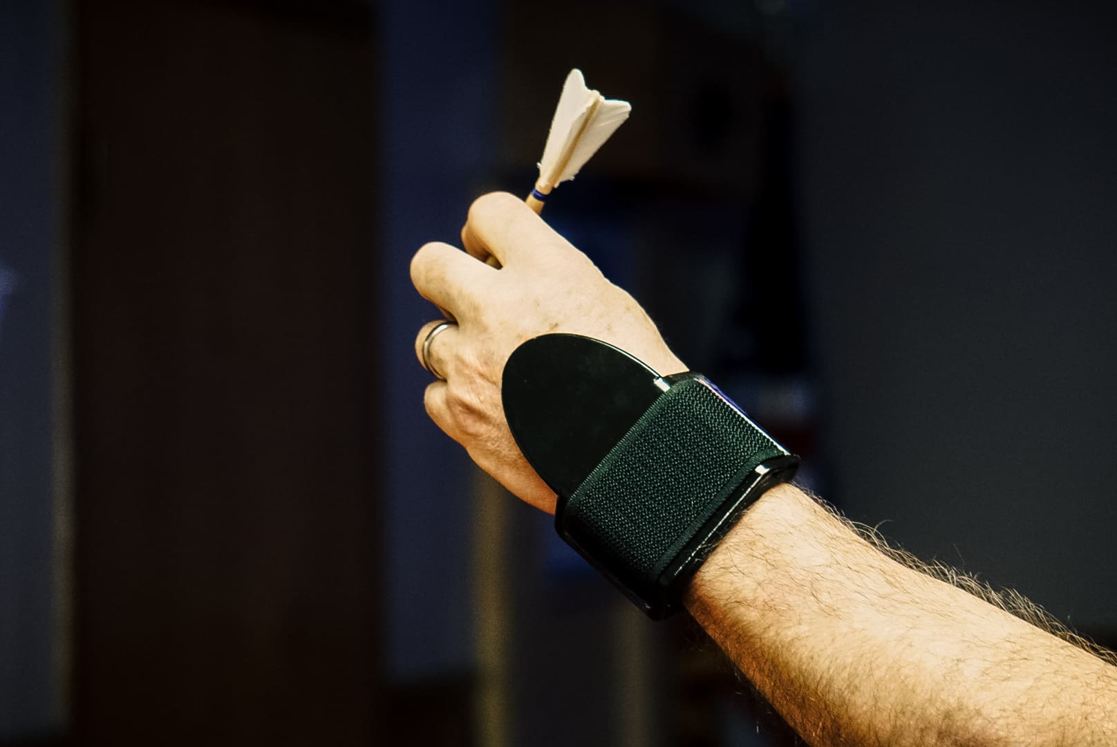 A person wearing a wrist brace holding something