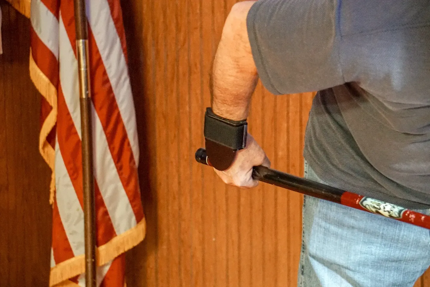 A man holding an umbrella in front of the american flag.